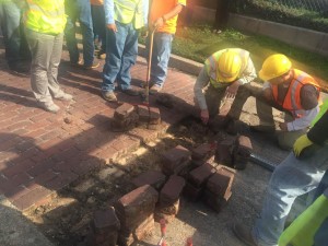 Construction crew replacing the bricks that were removed.