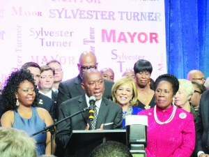 With daughter Ashley to his left and Congresswoman Sheila Jackson Lee to his right, State Representative Sylvester Turner makes his victory statement to become the 60th mayor of Houston, TX and the second African American